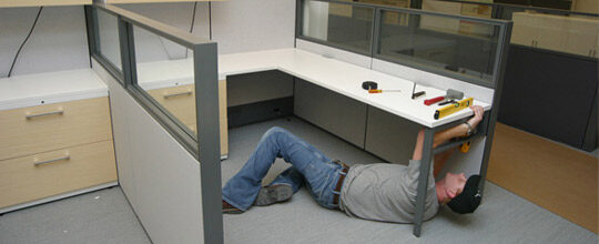 man repairing cubicle